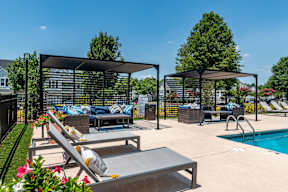 A poolside area with sun loungers and a pool.