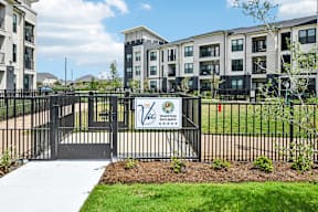 A black fence with a sign that says "Welcome to Westfield" in front of a building.