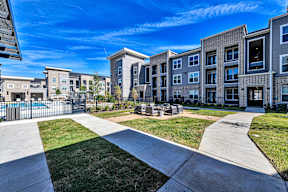 A sunny day at a residential complex with a clear blue sky.