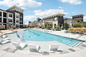 A pool with chairs around it and a sign that says "NO DIVING @ 6IN".