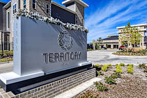 A sign for Territory 2020 is displayed in front of a building.