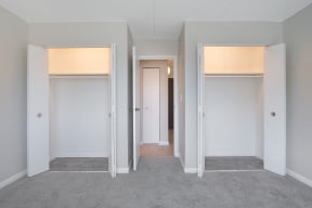 a living room with three doors and a hallway to three rooms