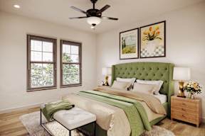 A bedroom with a green headboard and a white bed.