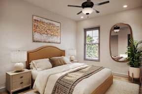 A bedroom with a large bed, a ceiling fan, and a painting on the wall.