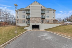 the entrance to an apartment building with a tunnel under it