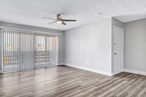 a bedroom with hardwood floors and a ceiling fan