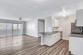 a kitchen and living room with a large window
