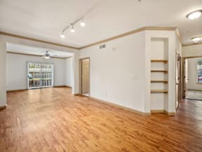 a living room with a hardwood floor and white walls
