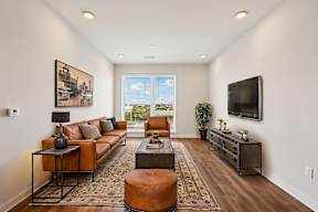 A living room with a brown leather couch and a coffee table.
