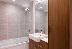 A bathroom with a white sink and a wooden door.