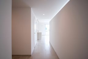 A long hallway with a white box in the distance.