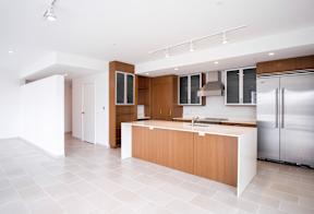 A modern kitchen with wooden cabinets and a white island.