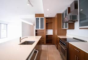 A modern kitchen with wooden cabinets and stainless steel appliances.