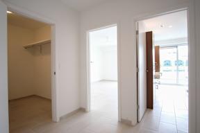 A white room with a doorway leading to another room.