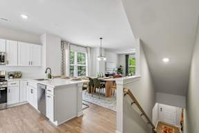A modern kitchen with white cabinets and a large island.