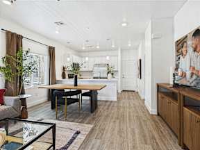 A modern kitchen with a dining table and chairs.