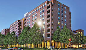 A large red brick building with trees in front of it.