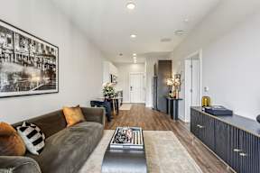 A living room with a brown couch and a coffee table.