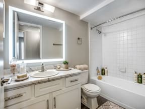 A white bathroom with a sink, toilet, and bathtub.