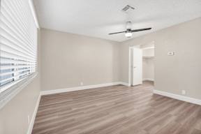 a bedroom with hardwood floors and a ceiling fan