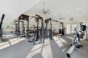 A spacious gym with a variety of equipment including treadmills, weights, and exercise machines.