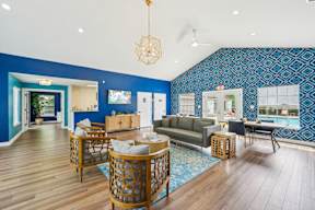 A living room with a blue wallpaper and wooden furniture.