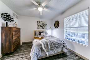 a bedroom with a bed and a ceiling fan