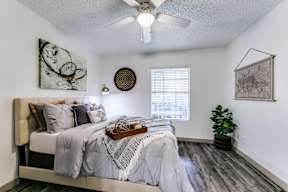 an attic bedroom with a bed and a ceiling fan