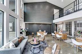 an open living room with couches and chairs and a dining room table