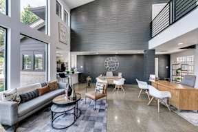 a living room with a couch and a table with chairs