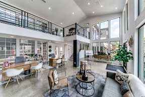 a living room with couches and chairs and a large balcony