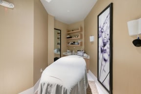a treatment room with a bed and a mirror