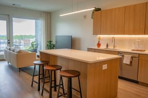 a kitchen with a counter top and three stools
