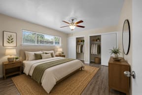 A bedroom with a large bed and a ceiling fan.