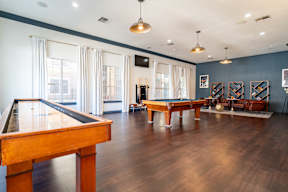 a game room with a pool table and ping pong