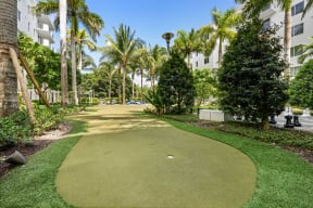 a golf course at a resort with palm trees