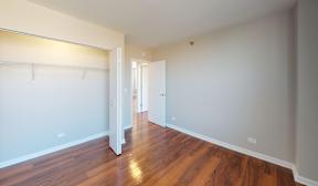 A room with a wooden floor and white walls.