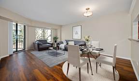 A dining room with a glass table and chairs.