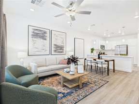 A living room with a couch, chairs, and a coffee table.