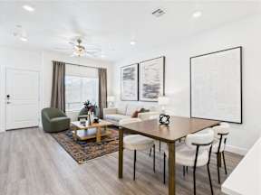 A modern living room with a wooden table and chairs.