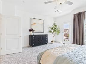 A bedroom with a bed, dresser, and a painting on the wall.