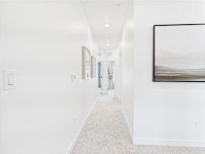 A long hallway with a painting on the wall.