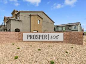 A sign that says "PROSPER 106" in front of a building.
