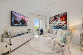 a living room with a white rug and a rocking horse