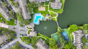 a birdseye view of a yard with a pool and a tennis court