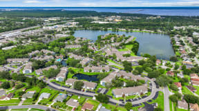 an aerial view of a neighborhood with a lake in the background
