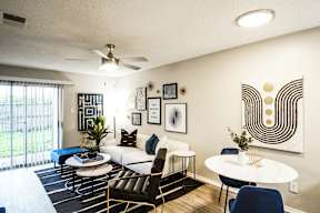a living room with a couch and a table and a ceiling fan