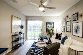 our apartments offer a living room with a ceiling fan and a balcony