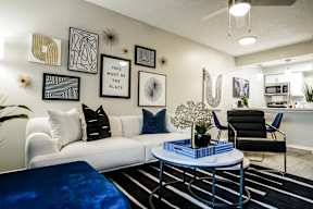 an open living room with a white couch and a coffee table