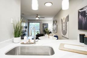 the view of the kitchen and living room from the counter top in a modern home